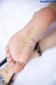 A close up of a person's foot with a pen.