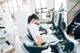 A woman sitting on a stationary bike in a gym.