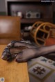 A pair of black stockings sitting on top of a wooden table.