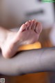 A close up of a person's foot with a ring on it.