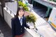 A woman in a school uniform standing on a balcony.