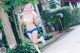 A woman in a bikini and headphones running down a street.