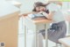 A woman sleeping on a desk in a classroom.