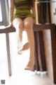 A woman sitting on top of a wooden table.