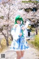 A woman in a blue and white dress holding a sword.