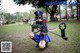 A woman dressed as a police officer holding a machine gun.