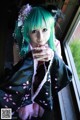 A woman with green hair wearing a black kimono.