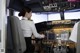 A woman sitting in the cockpit of an airplane.