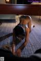 A woman laying on the floor in a hotel room.