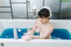 A woman sitting in a bathtub covered in foam.