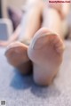 A close up of a person's feet on a bed.