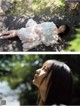 A woman laying on the ground in a white dress.