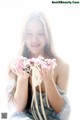 A woman holding a bunch of flowers in her hands.