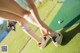 A woman putting a golf ball on a putting green.