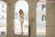 A woman in a white lingerie standing in an abandoned building.