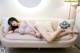 A woman laying on a white couch in a room.