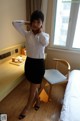 A woman standing in front of a window in a hotel room.