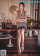 A woman sitting on top of a wooden table.