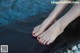 A woman's feet in a pool of water.